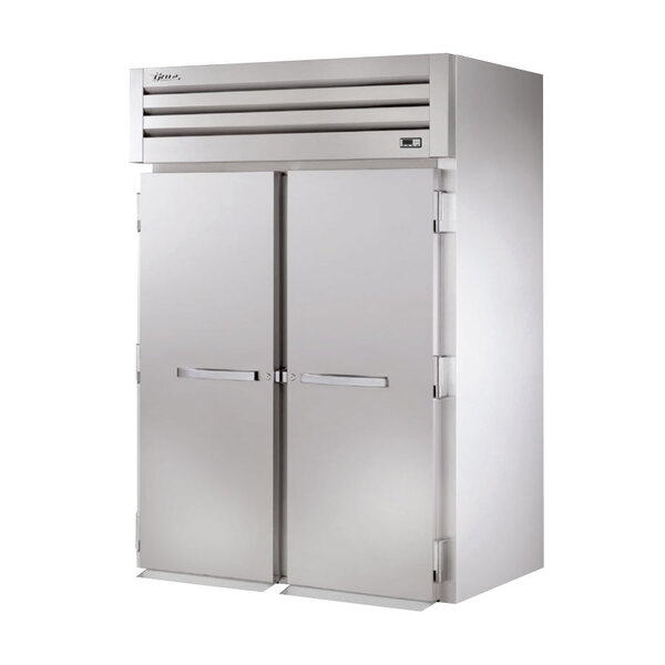 A True roll-in freezer with two solid doors.
