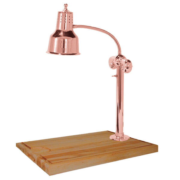A Hanson bright copper carving lamp on a maple wood surface.