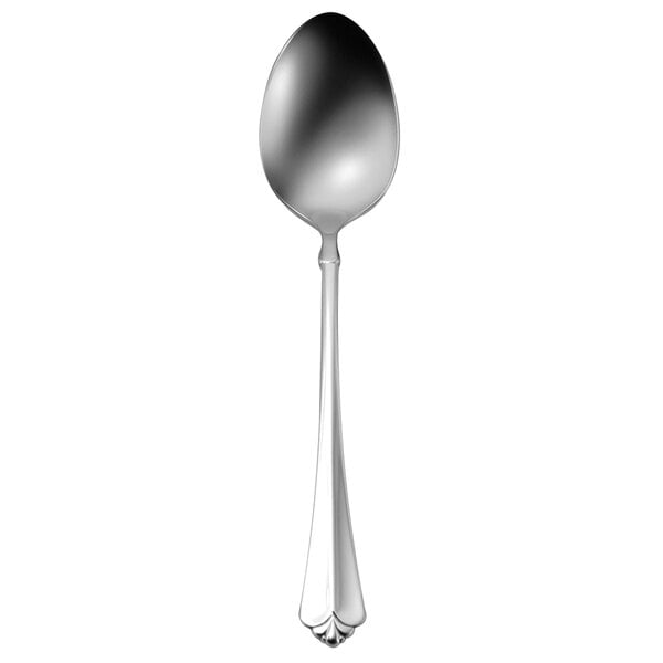 An Oneida Juilliard stainless steel serving spoon with a long handle.