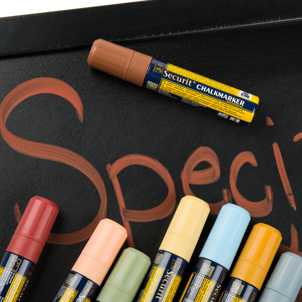 A chalkboard with assorted Earth tone American Metalcraft chalk markers.