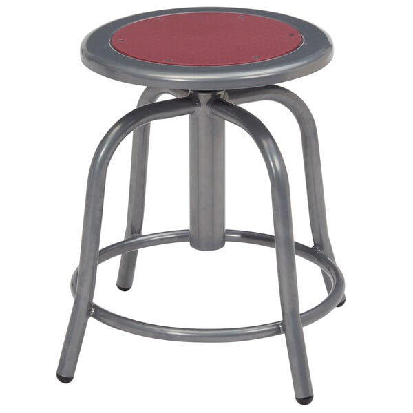 A National Public Seating lab stool with a gray metal base and a burgundy seat.