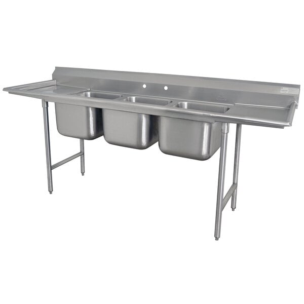 A stainless steel Advance Tabco Regaline three compartment sink with two drainboards.