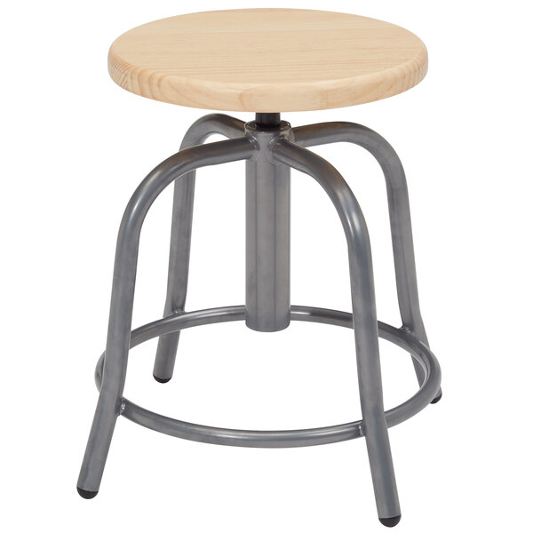 A National Public Seating lab stool with a round wooden seat.