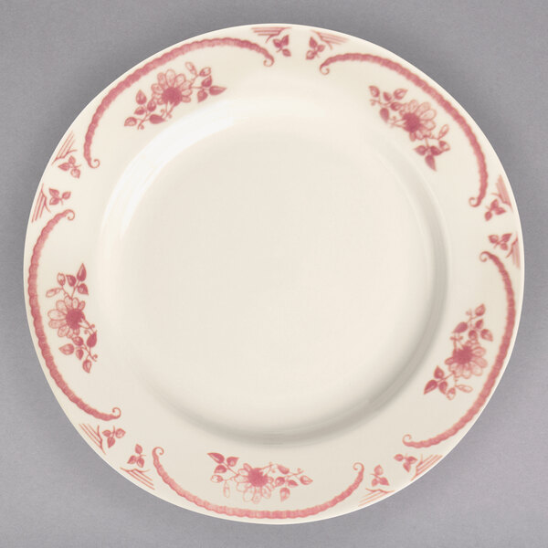 A close-up of a Homer Laughlin American White china plate with pink flowers on it.