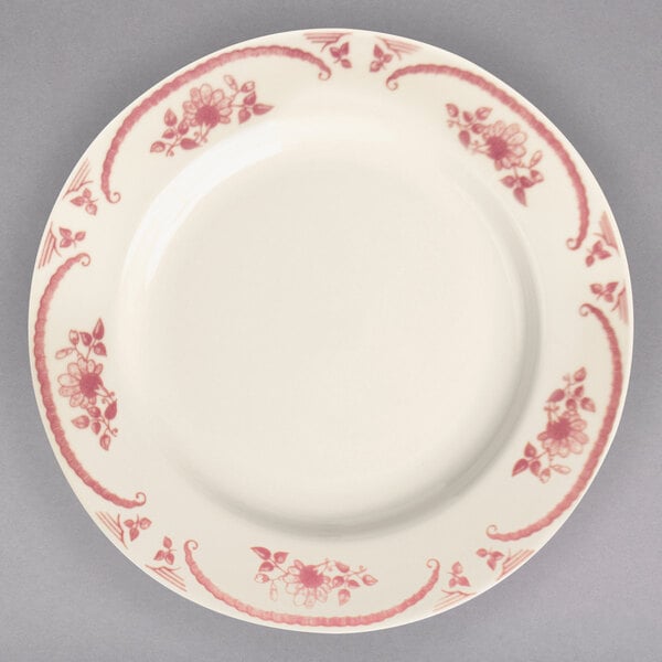 A white Homer Laughlin china plate with pink flowers on it.