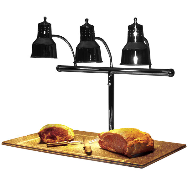 A Hanson Heat Lamps black carving station with three lights over meat on a cutting board.