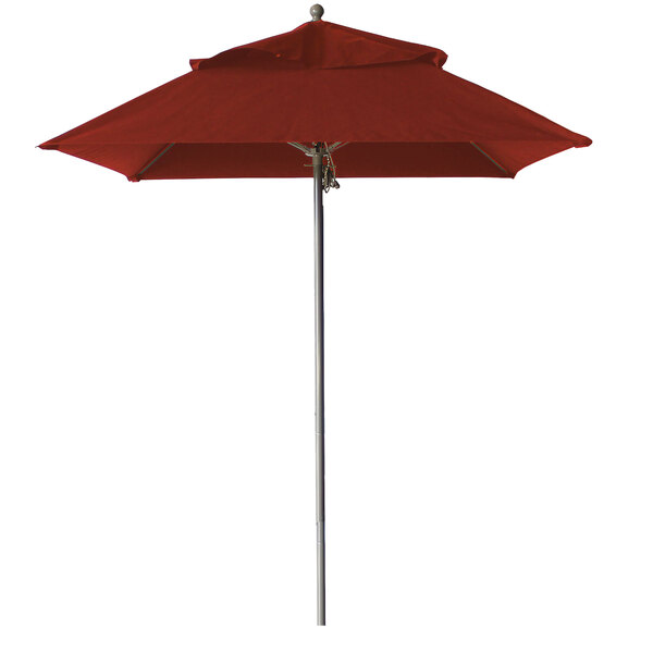 A red Grosfillex Windmaster umbrella on a white pole.