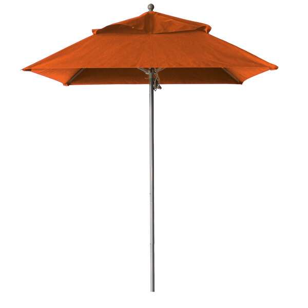 An orange Grosfillex Windmaster umbrella on an aluminum pole.