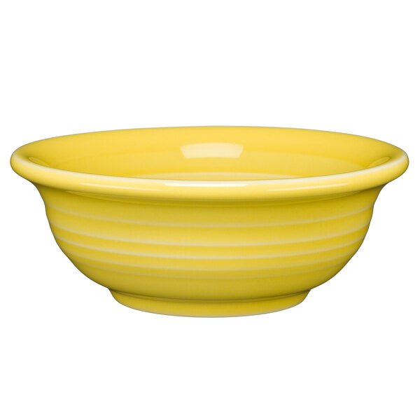 A close-up of a yellow Fiesta fruit/salsa bowl with a white rim.