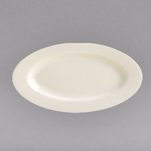 A white narrow rimmed china platter on a gray surface.
