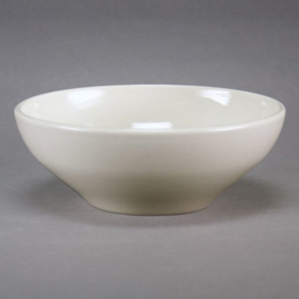A Homer Laughlin ivory china bowl on a gray surface.