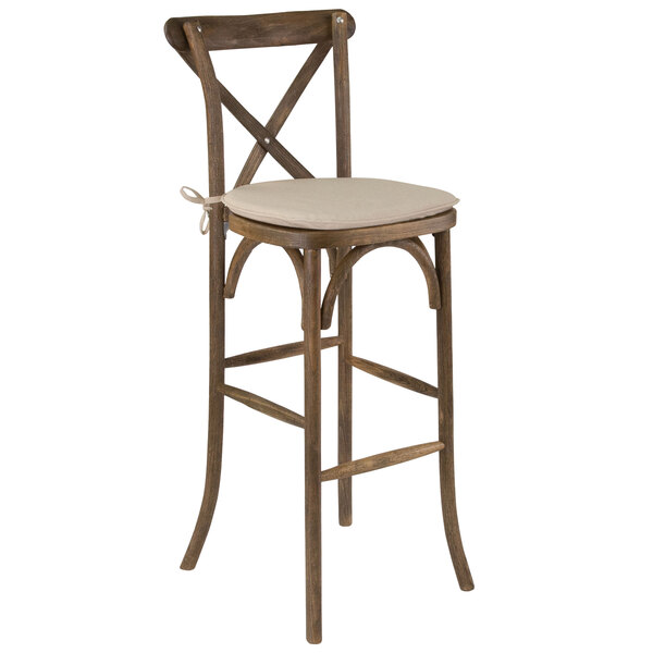 A Flash Furniture wooden barstool with a tan cushion.