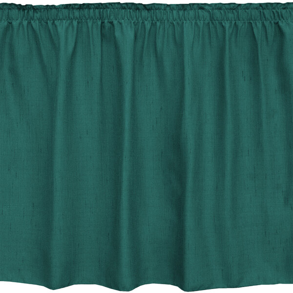 A green table skirt with ruffled edges.