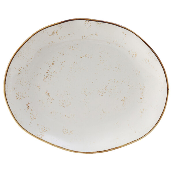 A white Tuxton china platter with brown specks and a gold rim.