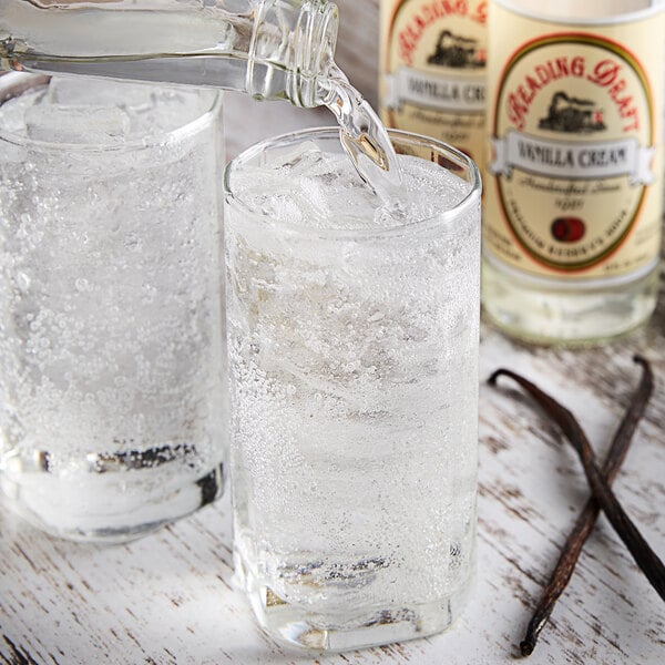 A bottle of Reading Soda Works Vanilla Cream being poured into a glass of ice.