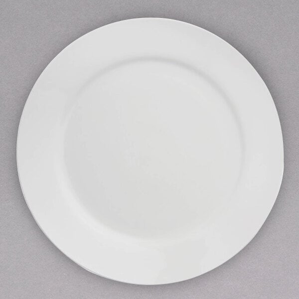 An Arcoroc white porcelain dinner plate with a white rim.