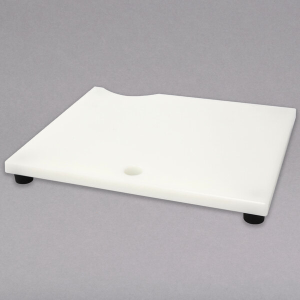 A white plastic chamber insert plate with a hole in the middle.