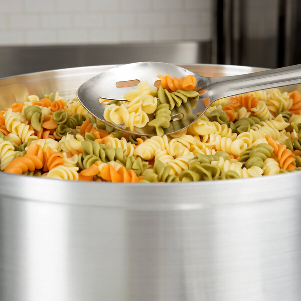 Regal Tricolor Rotini pasta in a pot with a spoon.