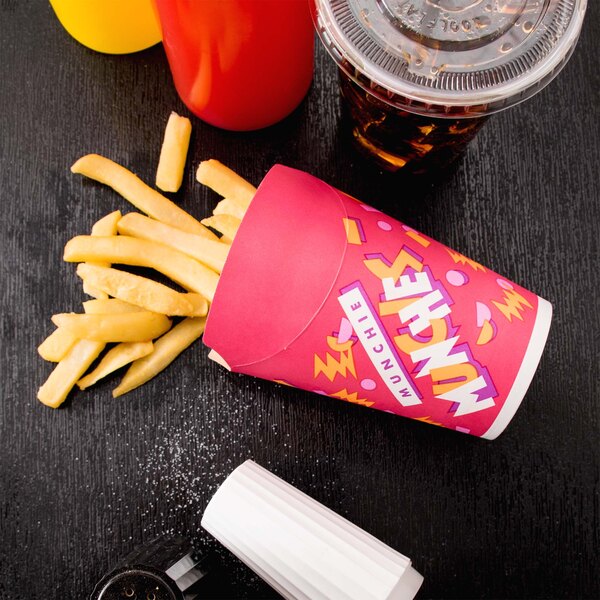 A Solo paper container of fries next to a drink with a lid.