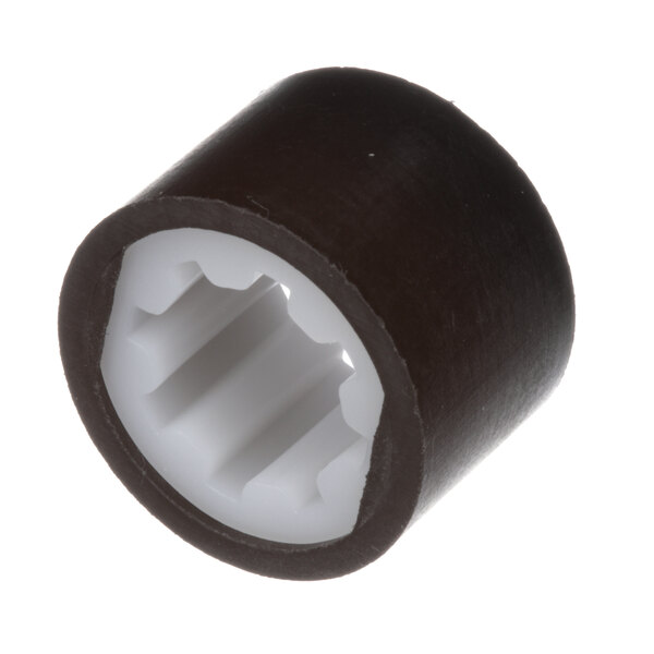A black and white plastic coupler sleeve with a white center.