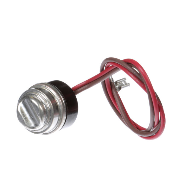 A close-up of a metal round object with a red and white wire and a metal button.