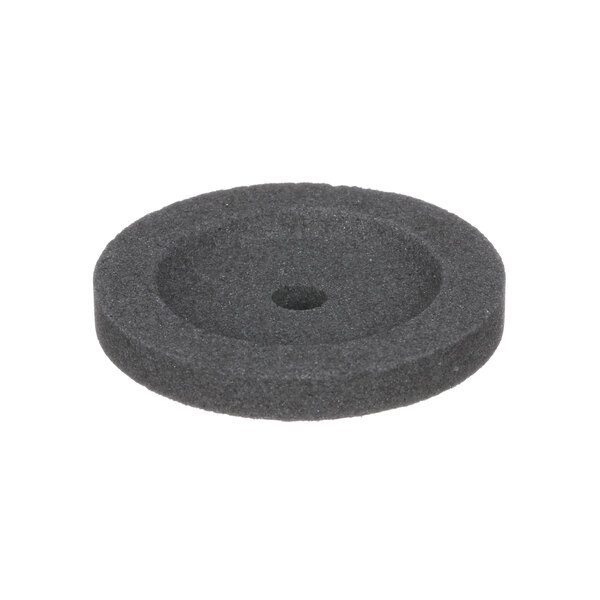 A black circular rubber disc with a hole in the center.