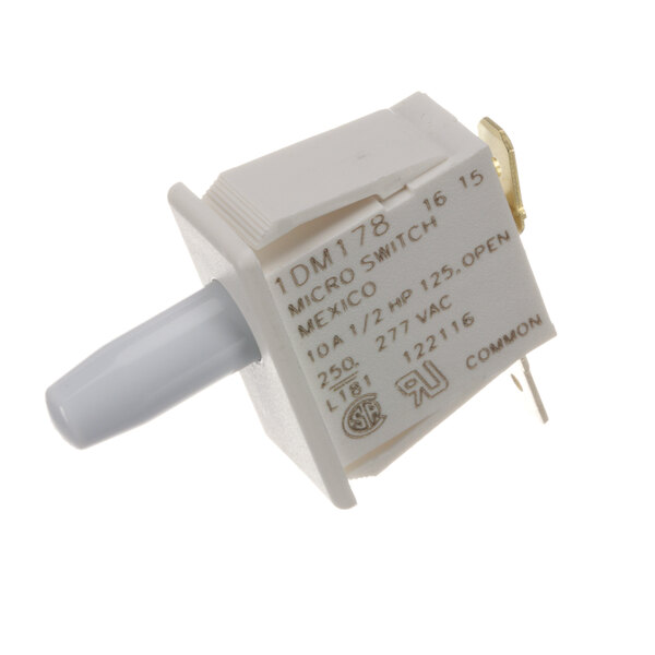 A close-up of a white American Dryer switch with a small white handle.