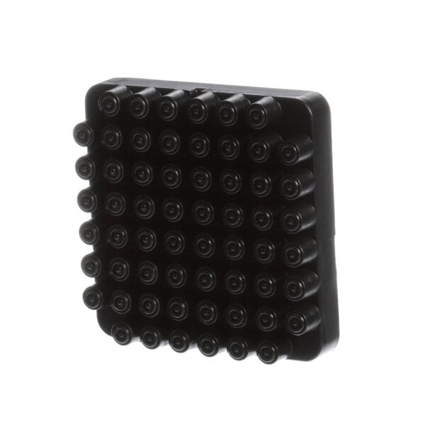 A black plastic pusher block with small round black circles on it.