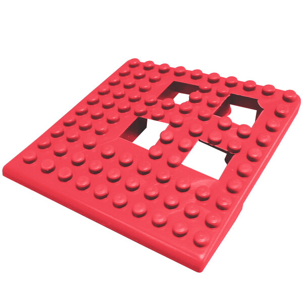 A red square Cactus Mat Dri-Dek corner piece with holes in it.