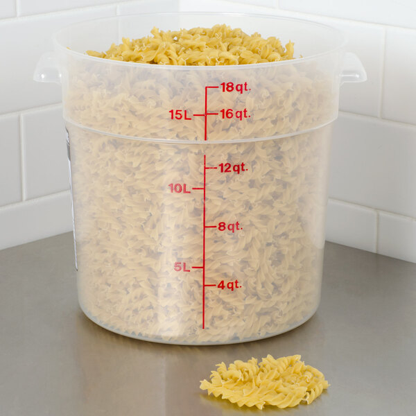 A Cambro translucent plastic food storage container filled with pasta.