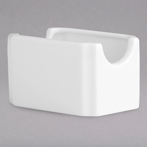 A white porcelain sugar caddy with a small handle.