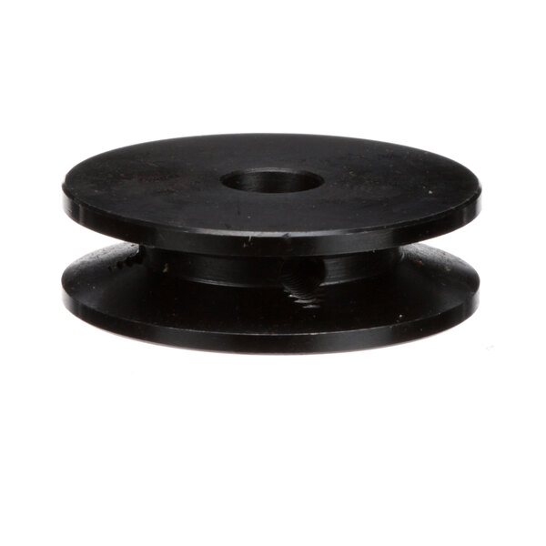 A close-up of a black Donper America pulley with a hole in it.