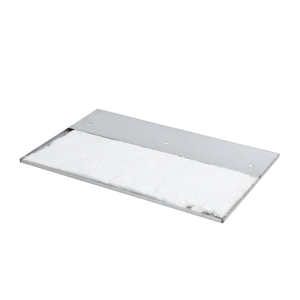 A white material insulation panel on a metal plate.