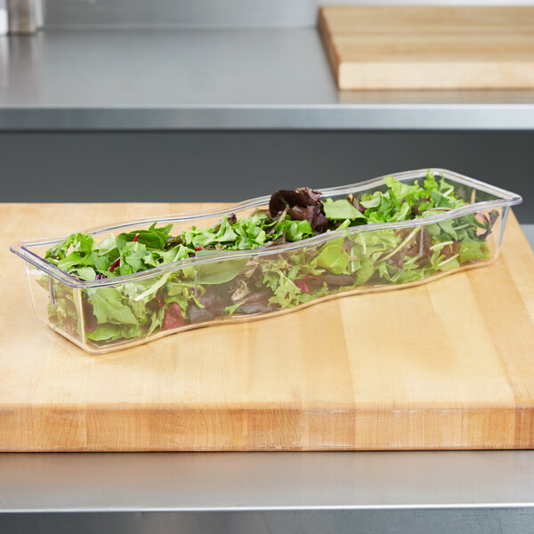 A salad in a Carlisle clear plastic wavy edge food pan.