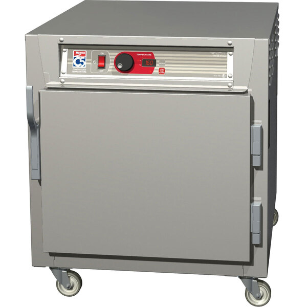 A large grey rectangular Metro C5 heated holding cabinet with wheels and a solid door.