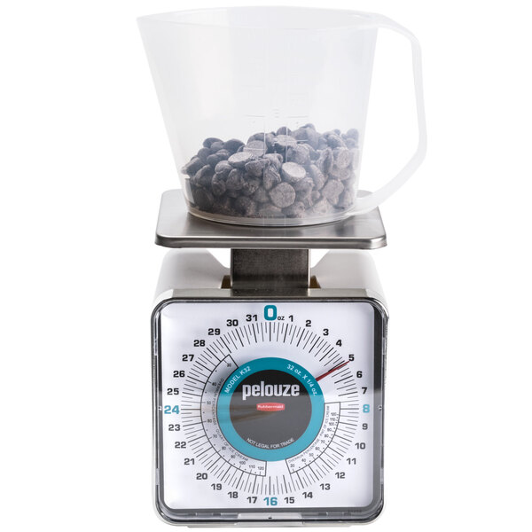 A Rubbermaid Pelouze portion scale with a measuring cup on it.
