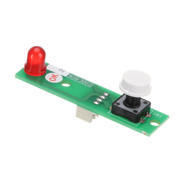 A green circuit board with a small red and white button.