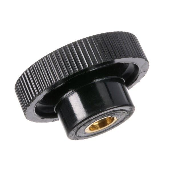 A black plastic knob with a gold center on a white background.