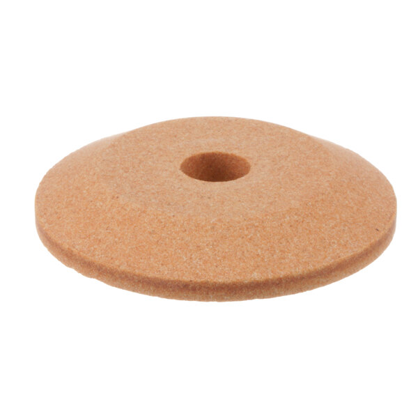 A round brown ceramic sharpening stone with a hole in the center.