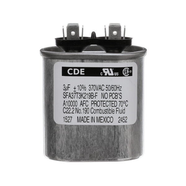 A round metal Jackson capacitor with black text that reads "CDE" on it.