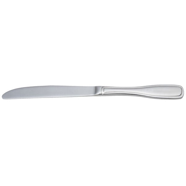 An Arcoroc stainless steel dinner knife with a white handle and silver blade.