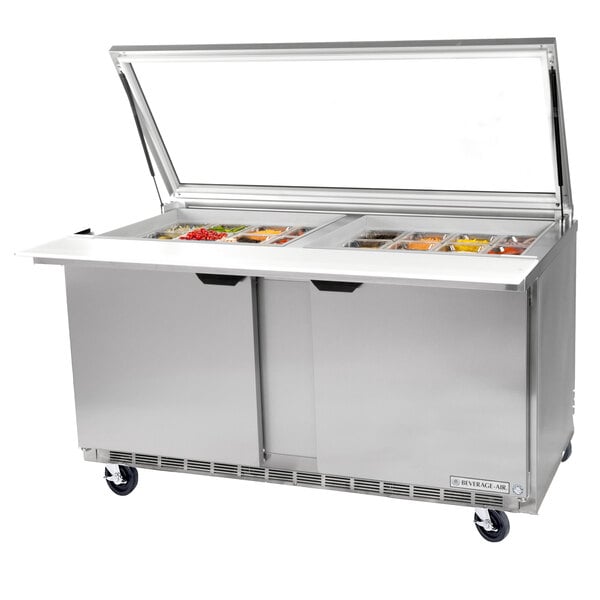A Beverage-Air stainless steel 3 door refrigerated sandwich prep table with a glass lid.