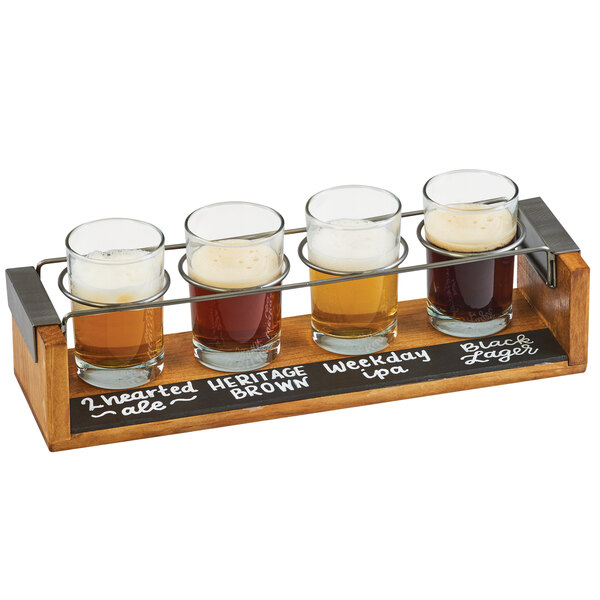 A Cal-Mil wooden tray with four beer glasses on it.