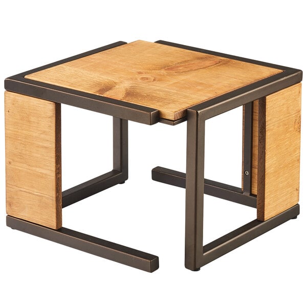 A Cal-Mil Sierra rustic pine and bronze metal square riser on a table.