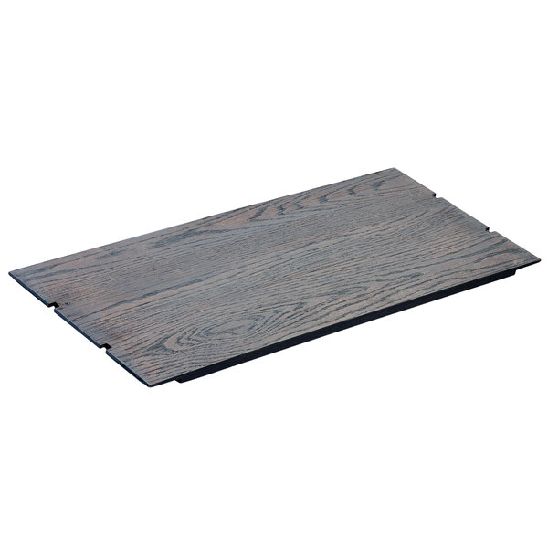 A Cal-Mil Ashwood gray oak wood notched rectangular riser shelf on a table.