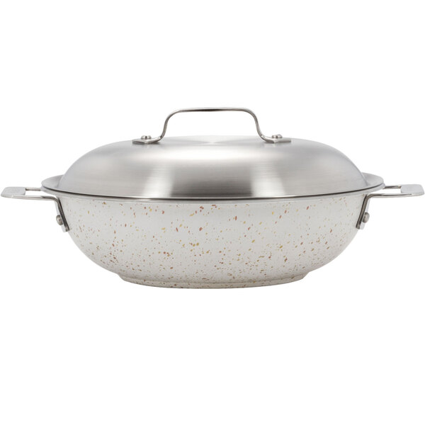 A Bon Chef stainless steel stir fry pan with a lid.