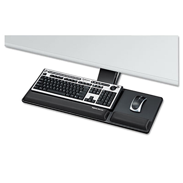 A black Fellowes Designer Suites compact keyboard tray with a keyboard and mouse on it.
