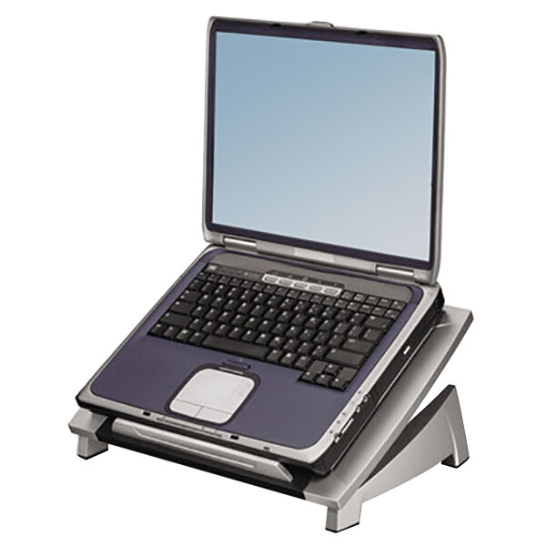 A black and silver Fellowes laptop riser with a laptop on it.