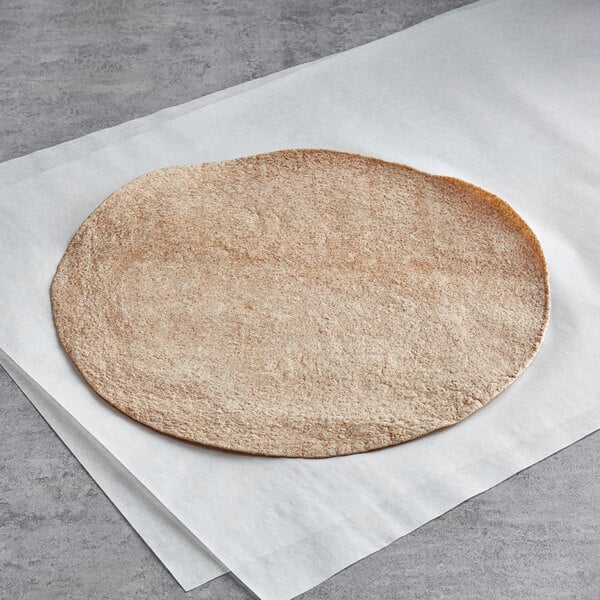 A Father Sam's Bakery whole wheat tortilla on white paper.