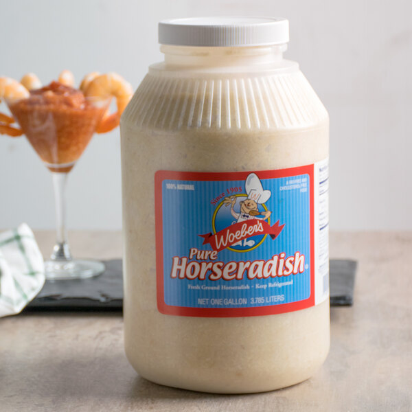 A close-up of a Woeber's Pure Horseradish jar on a table.